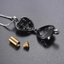 Silver heart-shaped pendant with gold accents on a gray background