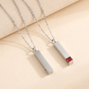Two necklaces with rectangular pendants on a beige background