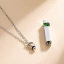 Silver necklace with pendant on a beige background