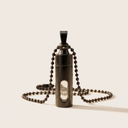 Black pendant necklace on a light beige background