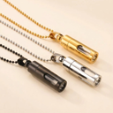 Three metallic necklaces with different color finishes on a beige background