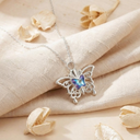 Butterfly necklace with a colorful center on a beige fabric background