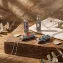 Decorative silver containers with gemstones on a wooden surface