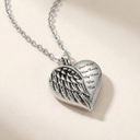 Silver angel wing pendant on a chain against a light background