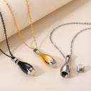 Three necklaces with unique pendants on a beige background