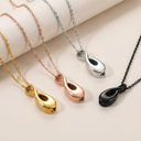 Four necklaces with different colored pendants on a beige background