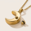Gold crescent moon necklace with a small bolt on a beige background