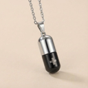 Cylindrical pendant with black and silver design on a beige background