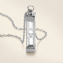 Silver hourglass pendant necklace on a beige background