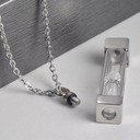 Silver necklace with a pendant on a gray surface