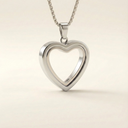 Silver heart-shaped pendant on a beige background