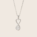 Silver necklace with a heart-shaped pendant featuring a paw print design on a light pink background.