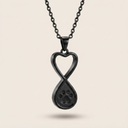 Black paw print infinity pendant necklace on a beige background