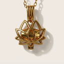 Gold lotus flower pendant on a light background