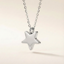 Silver star pendant necklace on a light beige background