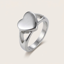 Silver heart-shaped ring on a light gray background