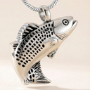 Silver fish-shaped pendant on a beige background