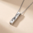 Silver pendant necklace on a beige background